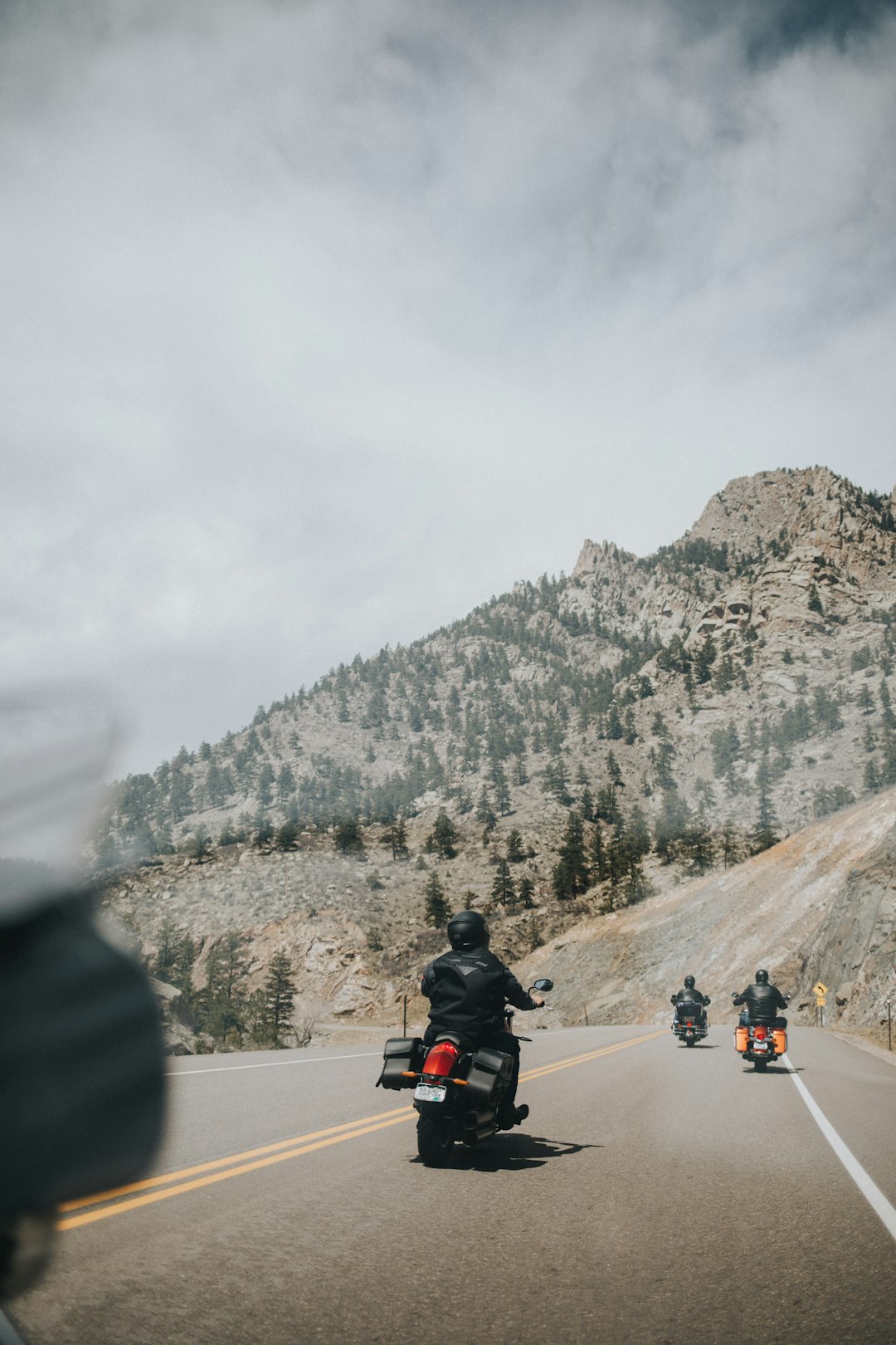 person in black jacket riding motorcycle on road during daytime