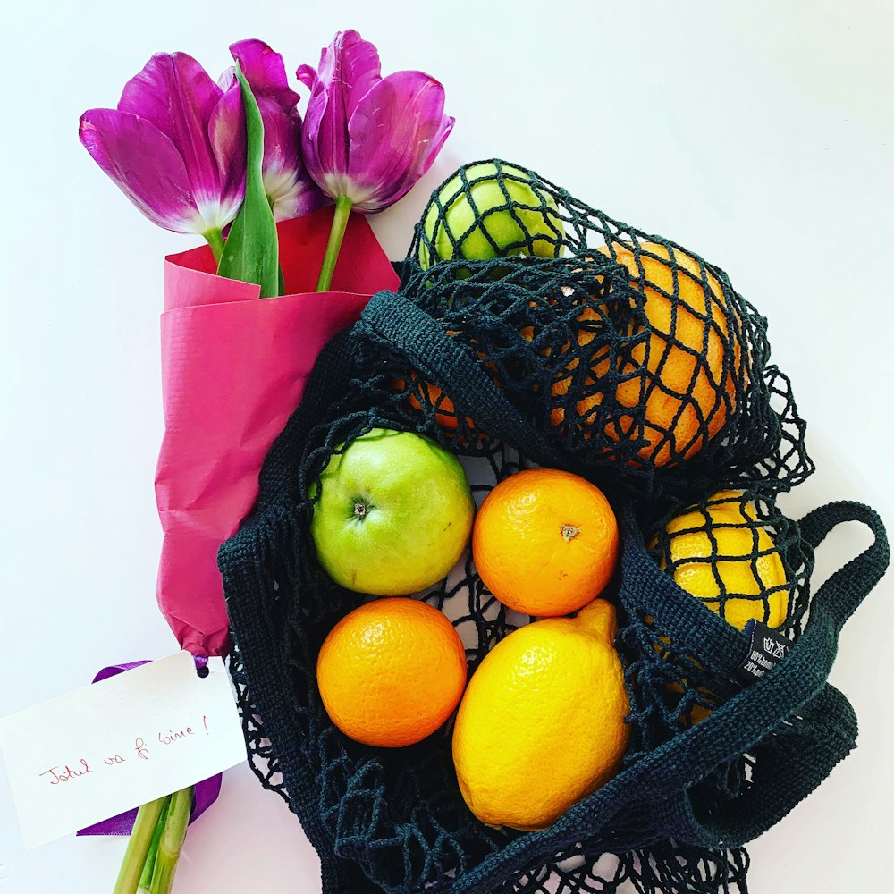 yellow lemon fruit on black and brown basket