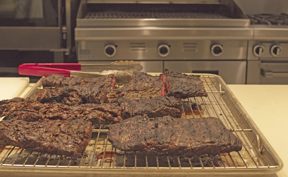 grilled meat on gray metal grill