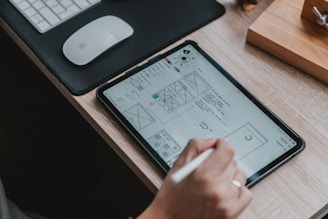 A designer working on a digital tablet creating visuals.
