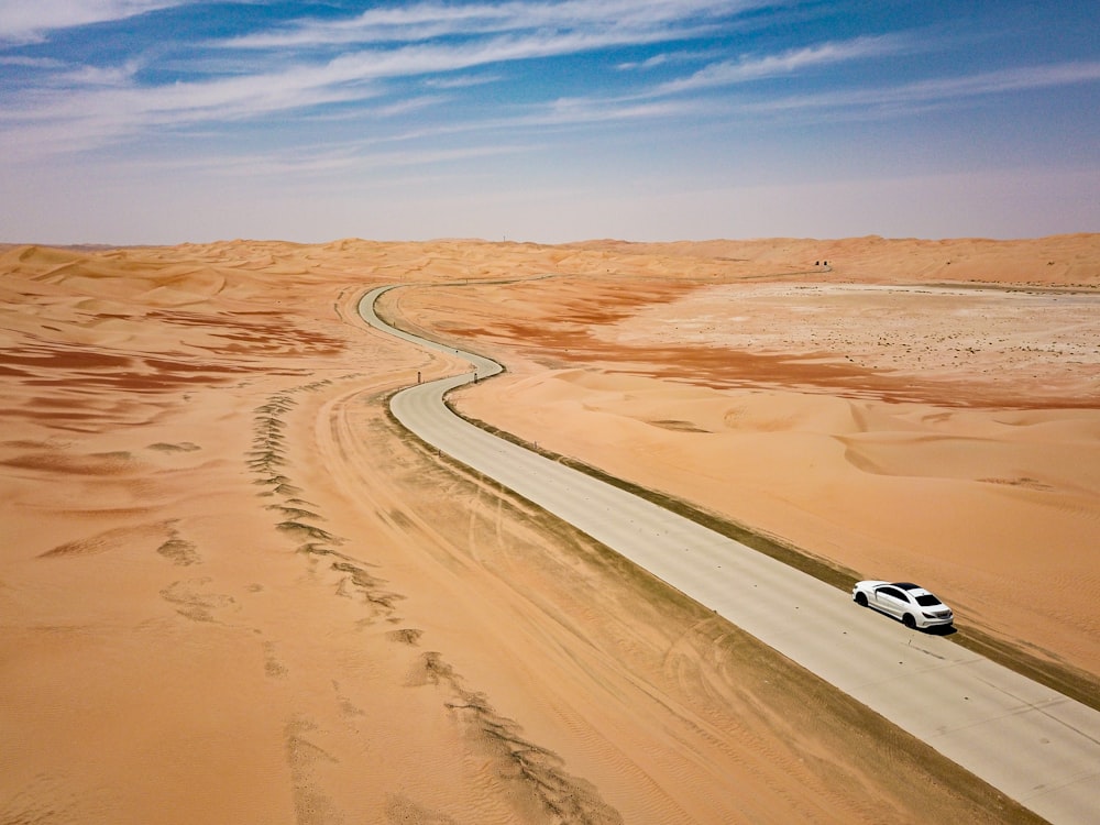 white car on brown sand