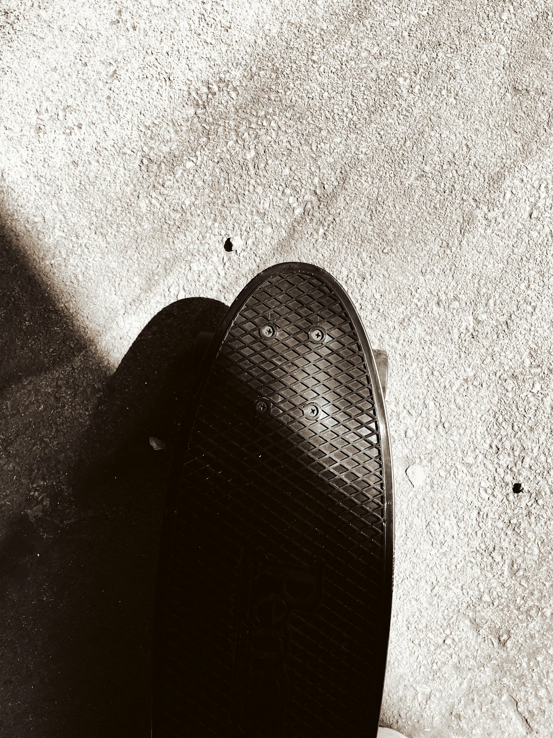 black flip flop on gray concrete floor