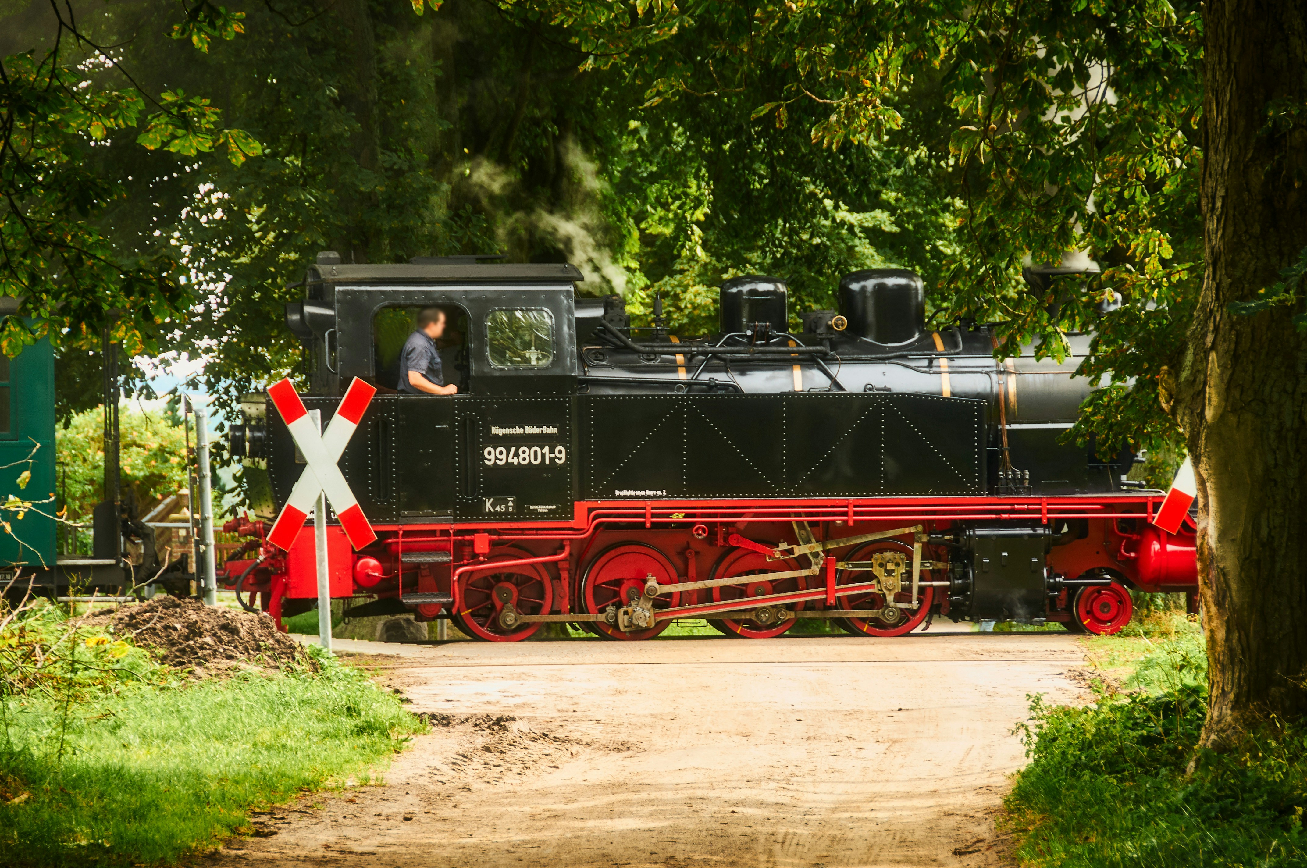 black and red train on rail tracks