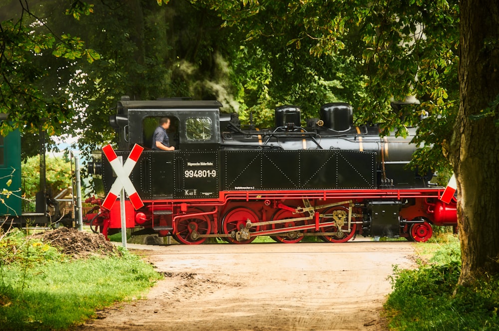 black and red train on rail tracks