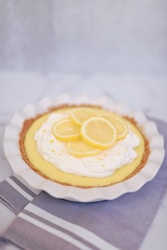 yellow and white cupcake on white and blue checkered textile