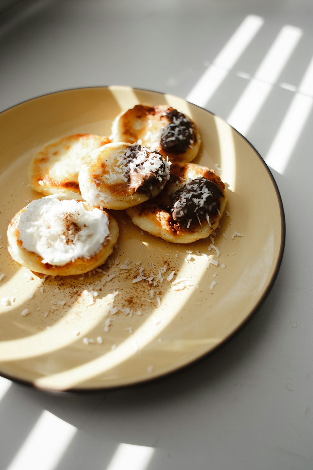 white ceramic plate with brown and white pastry