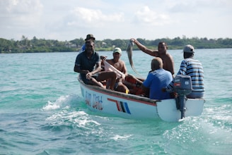 people riding on white and blue boat on sea during daytime