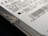 Close-up view of a hard drive with visible text and a barcode. The focus is on the details of the labeling, including technical specifications and a recognizable logo. The image captures the edge of the hard drive with a visible screw.
