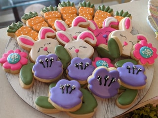 A tray of adorable animal-shaped cookies decorated with bright icing