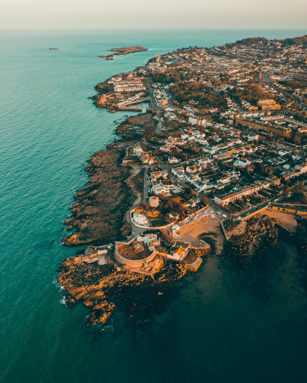 aerial view of city near body of water during daytime