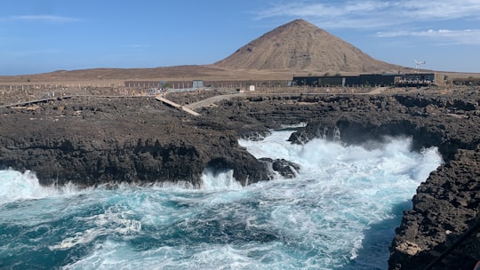 brown mountain near body of water during daytime in Sal Cape Verde