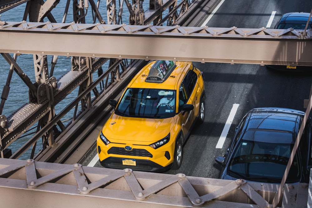 yellow car on gray concrete bridge during daytime
