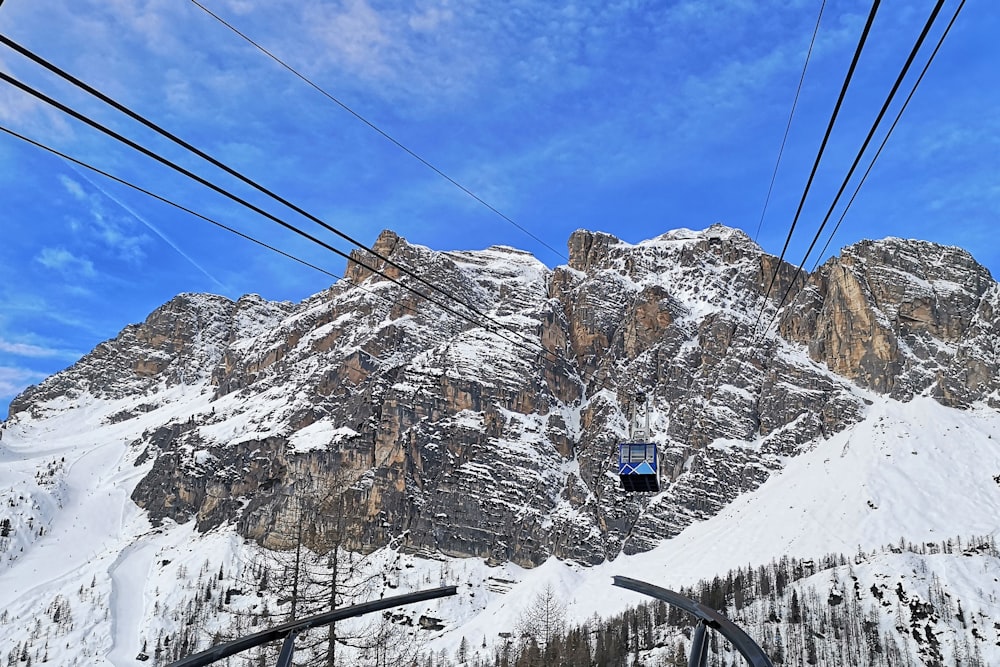 cable cars over snow covered mountain