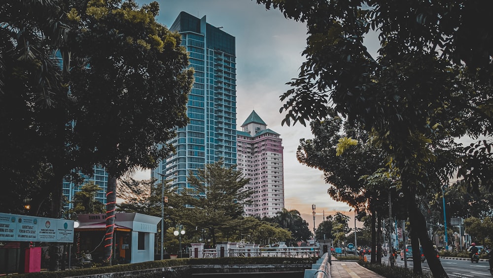 white and blue concrete building near green trees during daytime