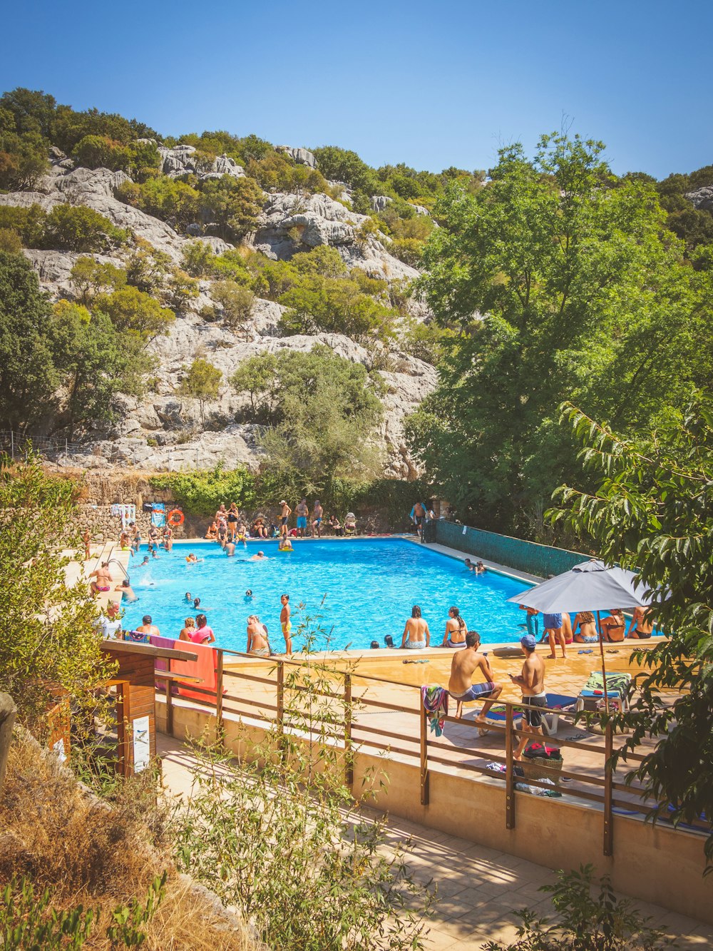 people swimming on beach during daytime