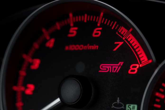 black and red speedometer at 0