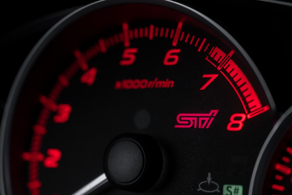 black and red speedometer at 0