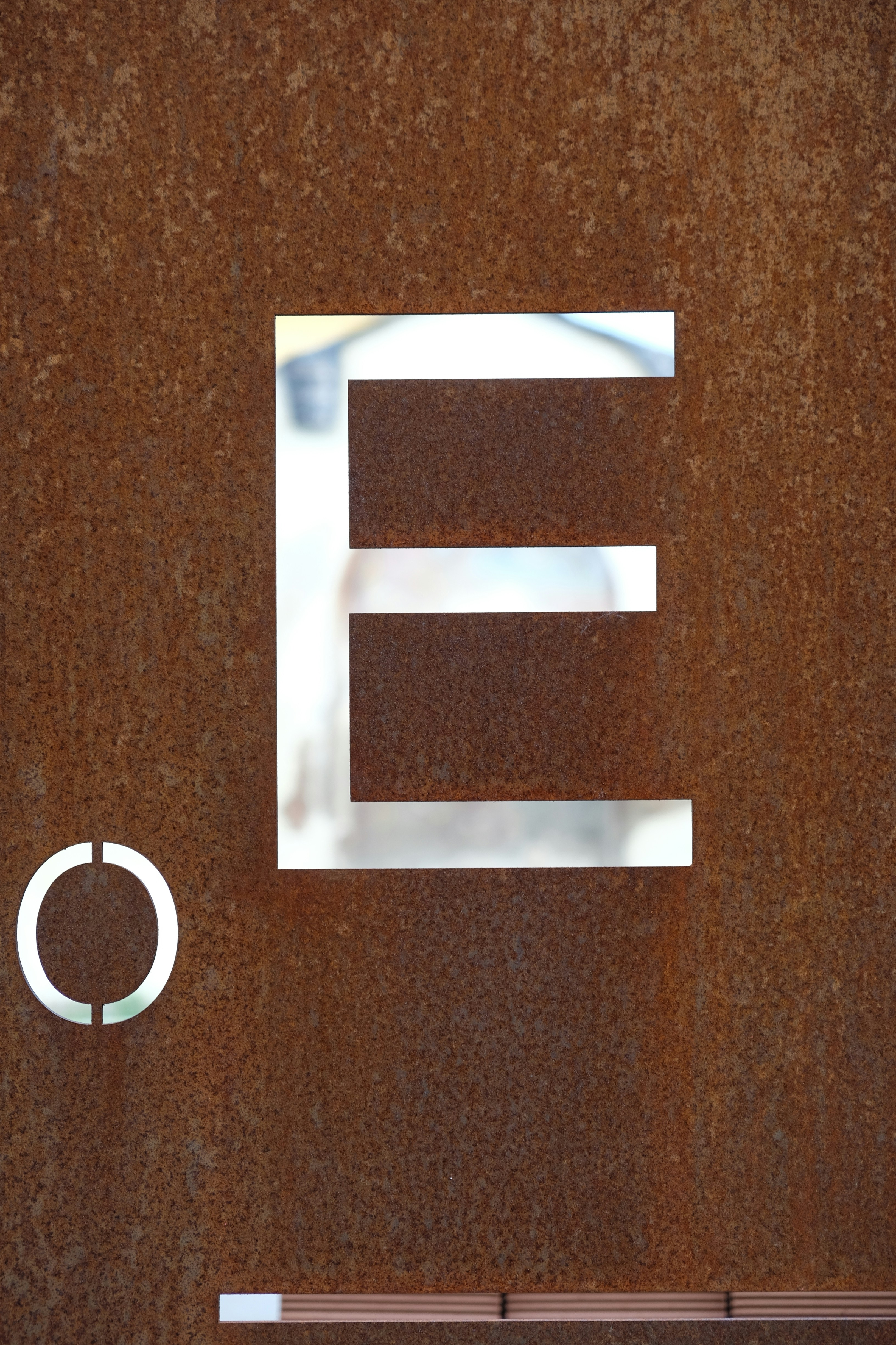 silver letter b on brown textile