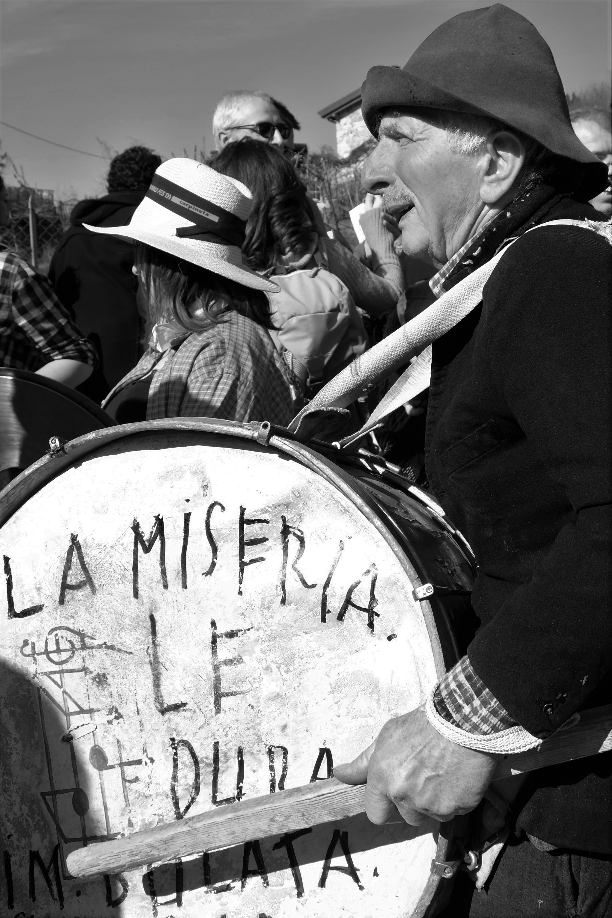 grayscale photo of man playing drum