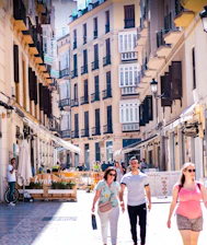 A vibrant street scene in Tirana with colorful buildings and lively locals.