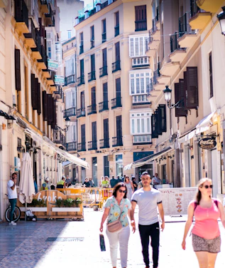 A lively street scene in central Tirana with colorful buildings and people exploring on foot.