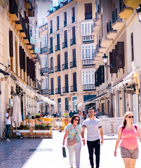 A lively street scene in central Tirana with colorful buildings and people exploring on foot.