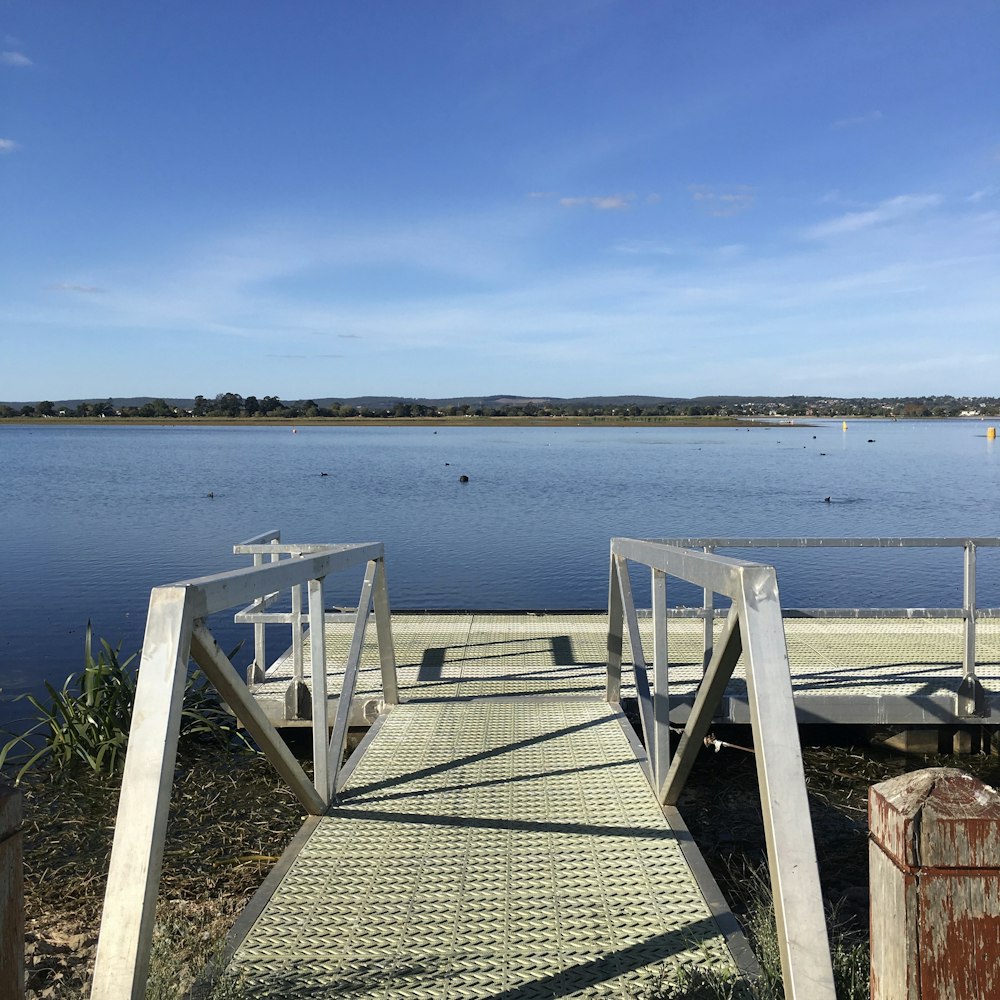 gray wooden dock on sea during daytime