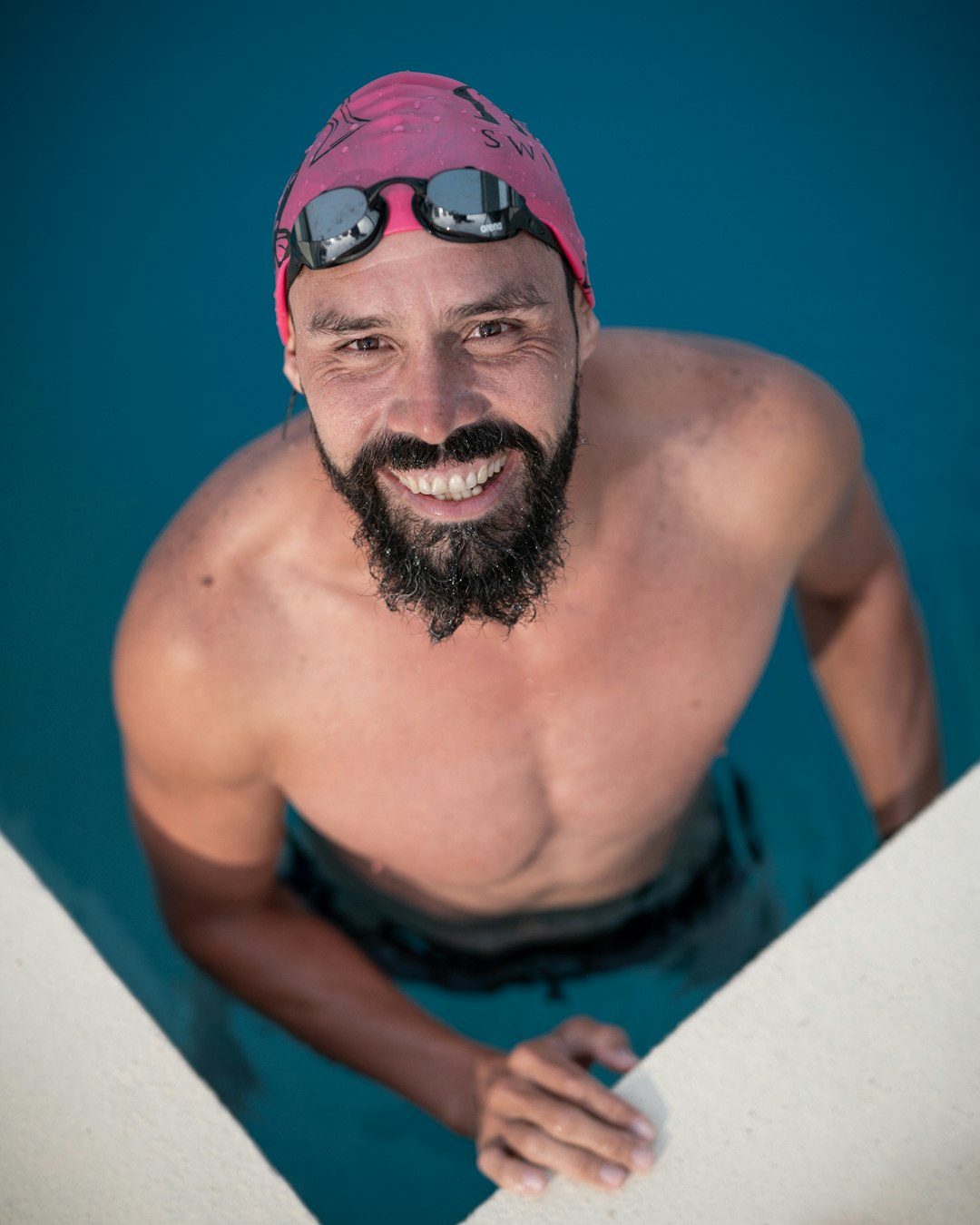 topless man wearing blue goggles