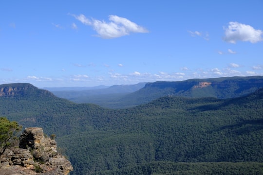green mountains under blue sky during daytime in Blue Mountains National Park Australia