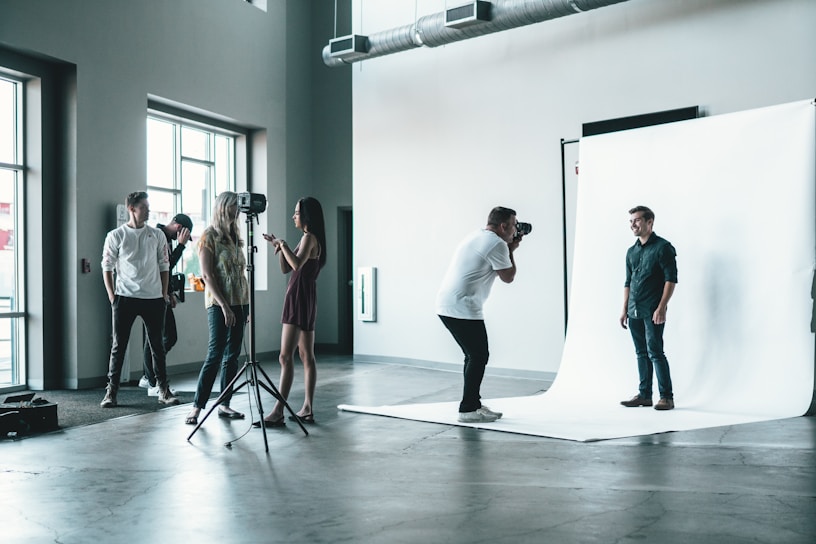 A vibrant behind-the-scenes shot of a photoshoot with models and photographers in action.