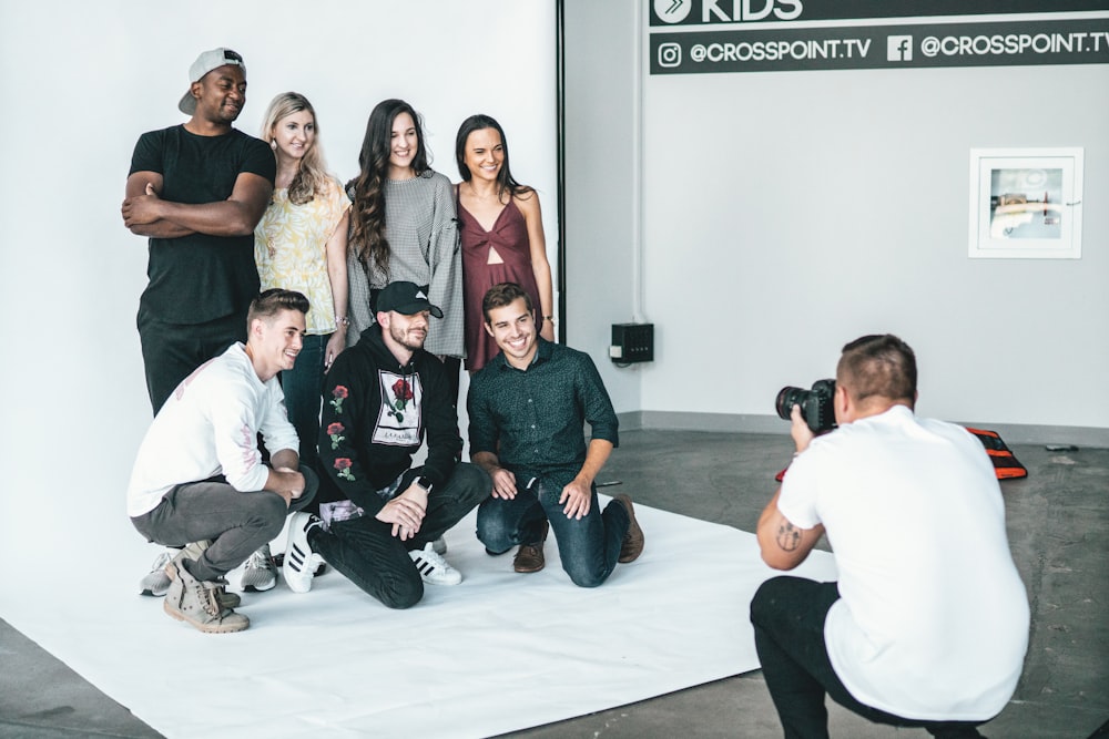 group of people sitting on white floor