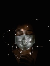 A comfortable, lightweight LED mask glowing softly on a smiling woman’s face.