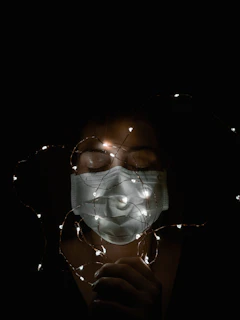 Close-up of the photon therapy mask's LED lights glowing softly against a calming blue background.