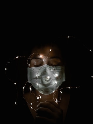 A comfortable, lightweight LED mask glowing softly on a smiling woman’s face.