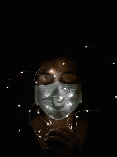 Close-up of the photon therapy mask's LED lights glowing softly against a calming blue background.