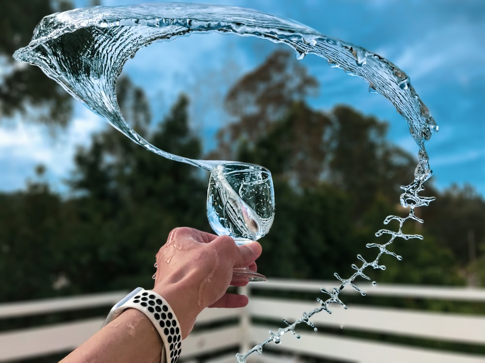 person holding clear glass bowl