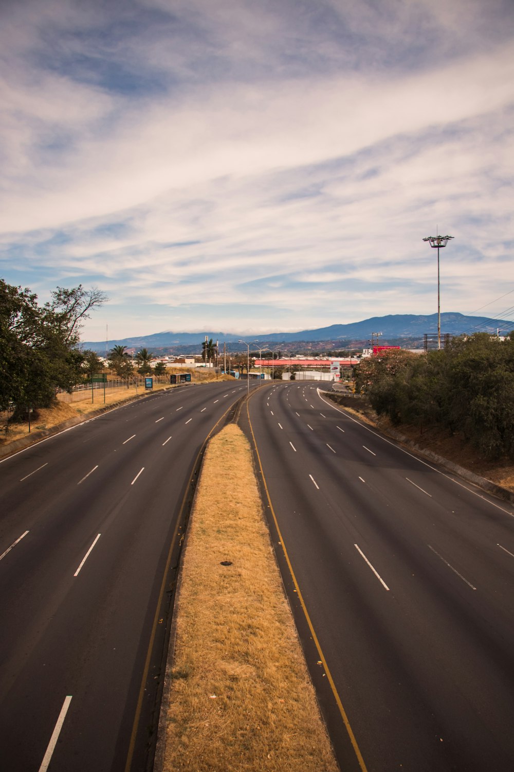 gray asphalt road under blue sky during daytime