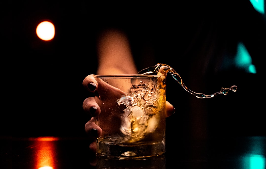 clear drinking glass with ice cubes, drinking through the quarantine