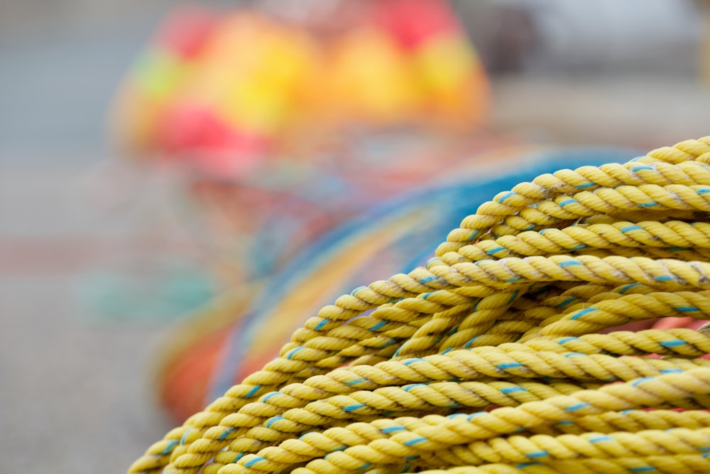 yellow and green rope on persons hand