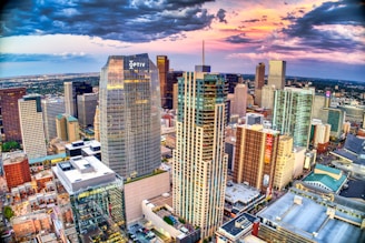 high rise buildings under white clouds and blue sky during daytime