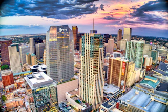 high rise buildings under white clouds and blue sky during daytime