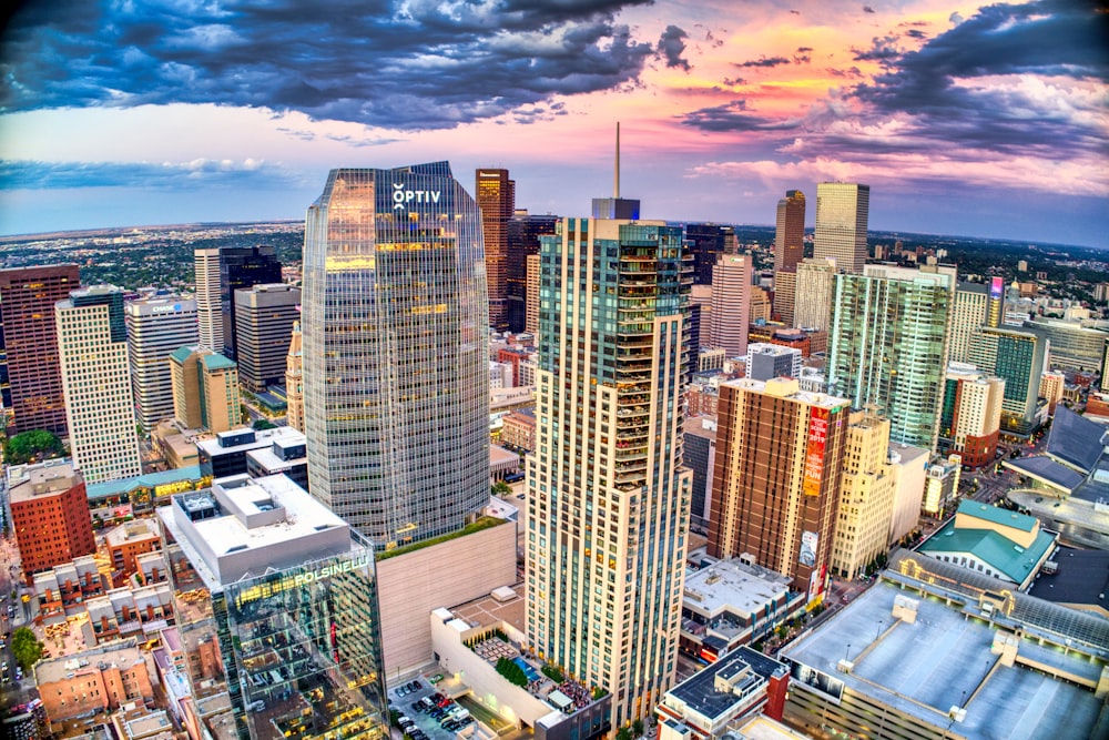 high rise buildings under white clouds and blue sky during daytime