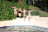 Children playing happily in a sparkling heated pool surrounded by lush tropical plants.