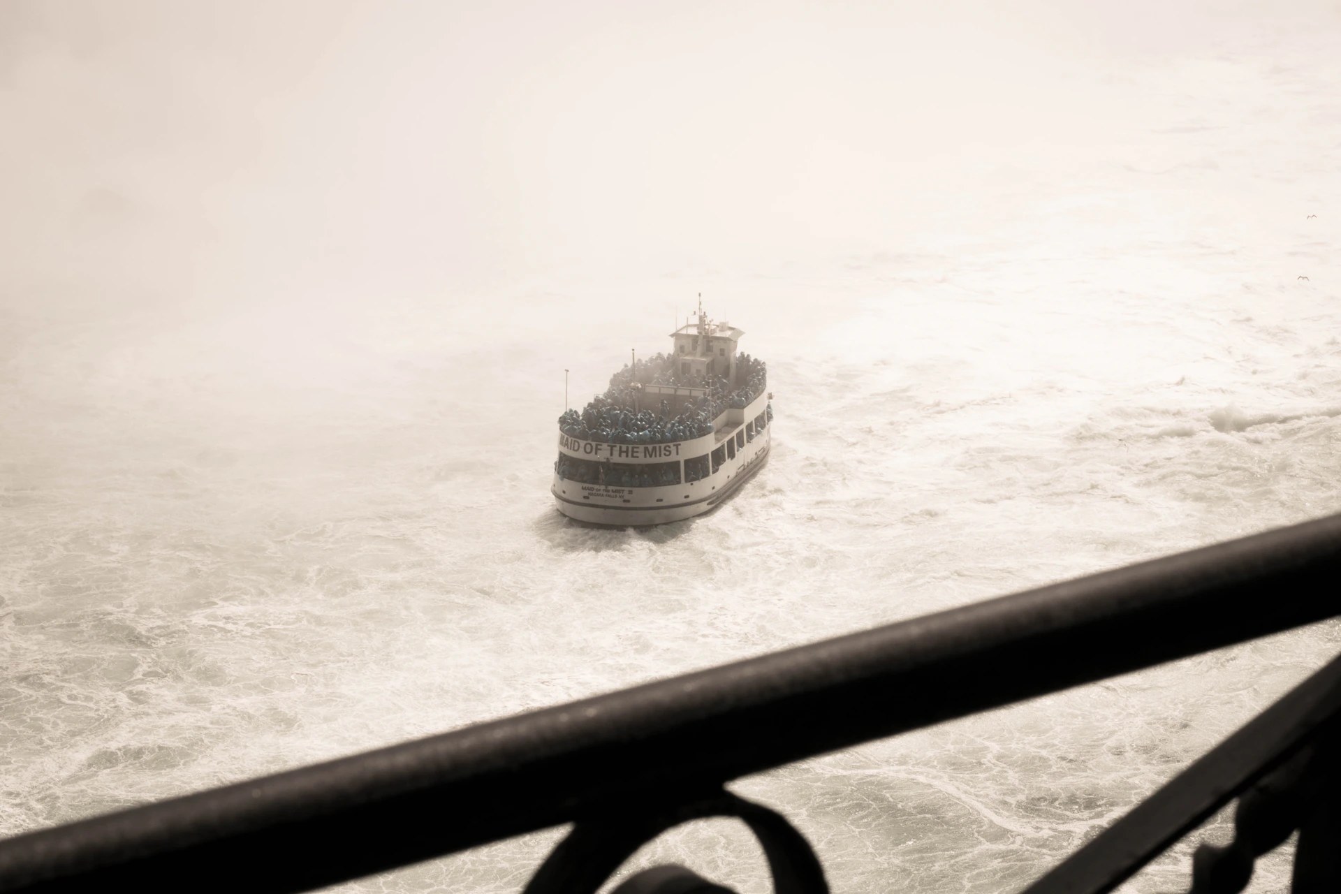 The ferry boat cutting through the misty morning waters, carrying eager explorers toward the wild beauty of Isle Royale’s rugged coastline.