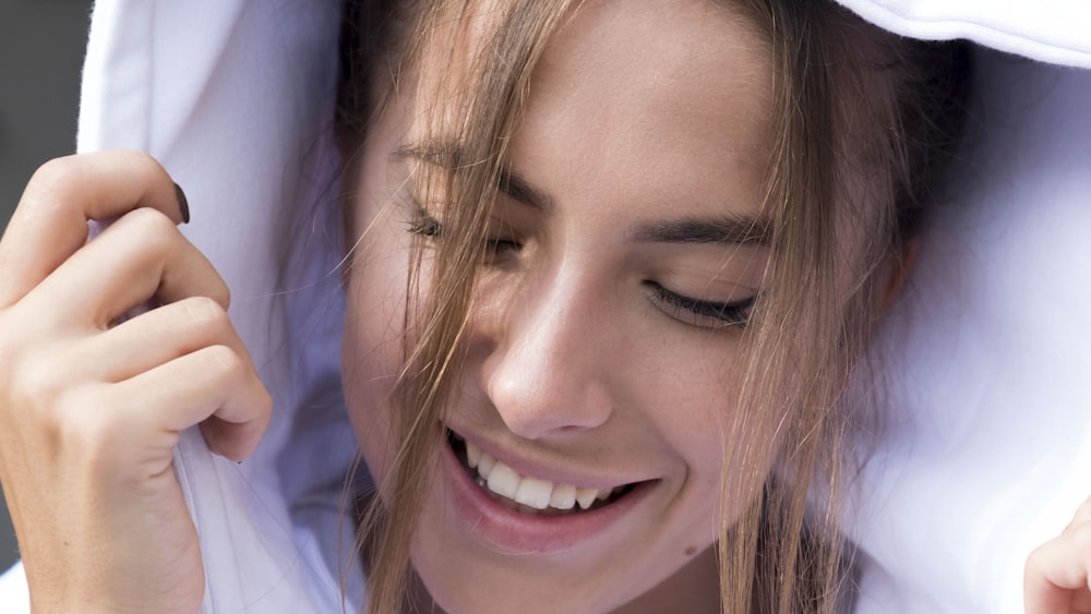 smiling woman in white shirt