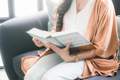 woman in brown robe reading book