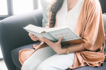 woman in brown robe reading book