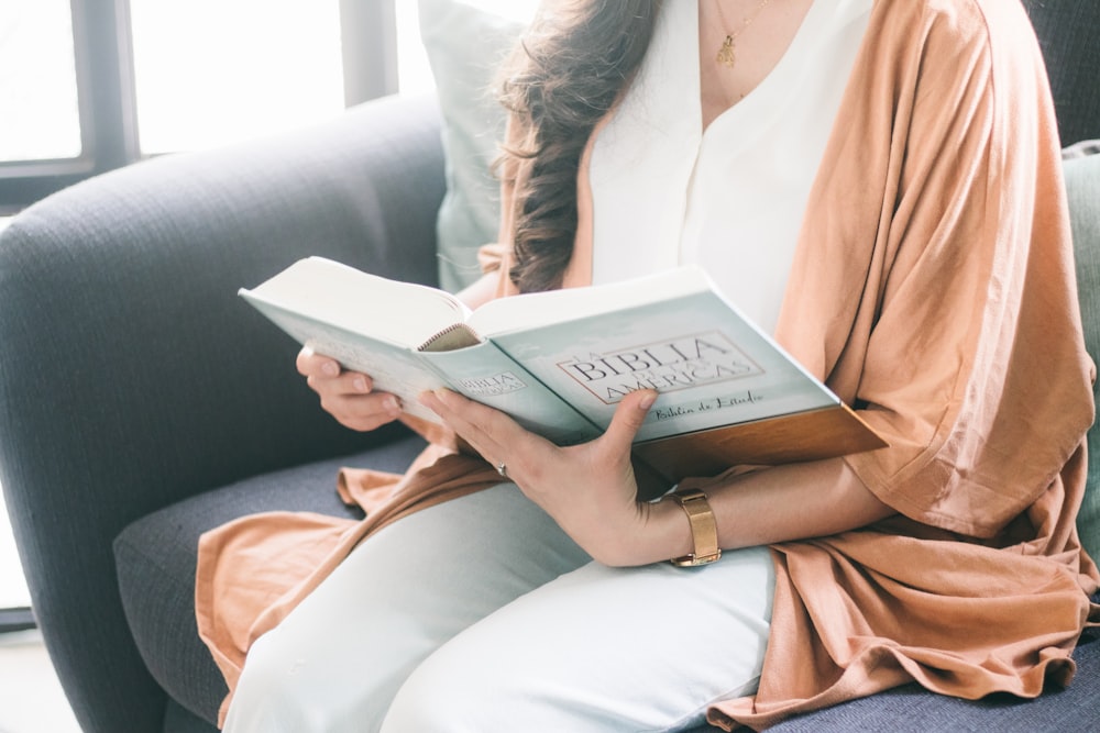 woman in brown robe reading book