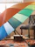 Close-up of a sleek umbrella stand holding colorful umbrellas next to a decorative bowl.