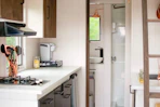 Compact kitchen area with sleek appliances and tidy countertop in the studio.